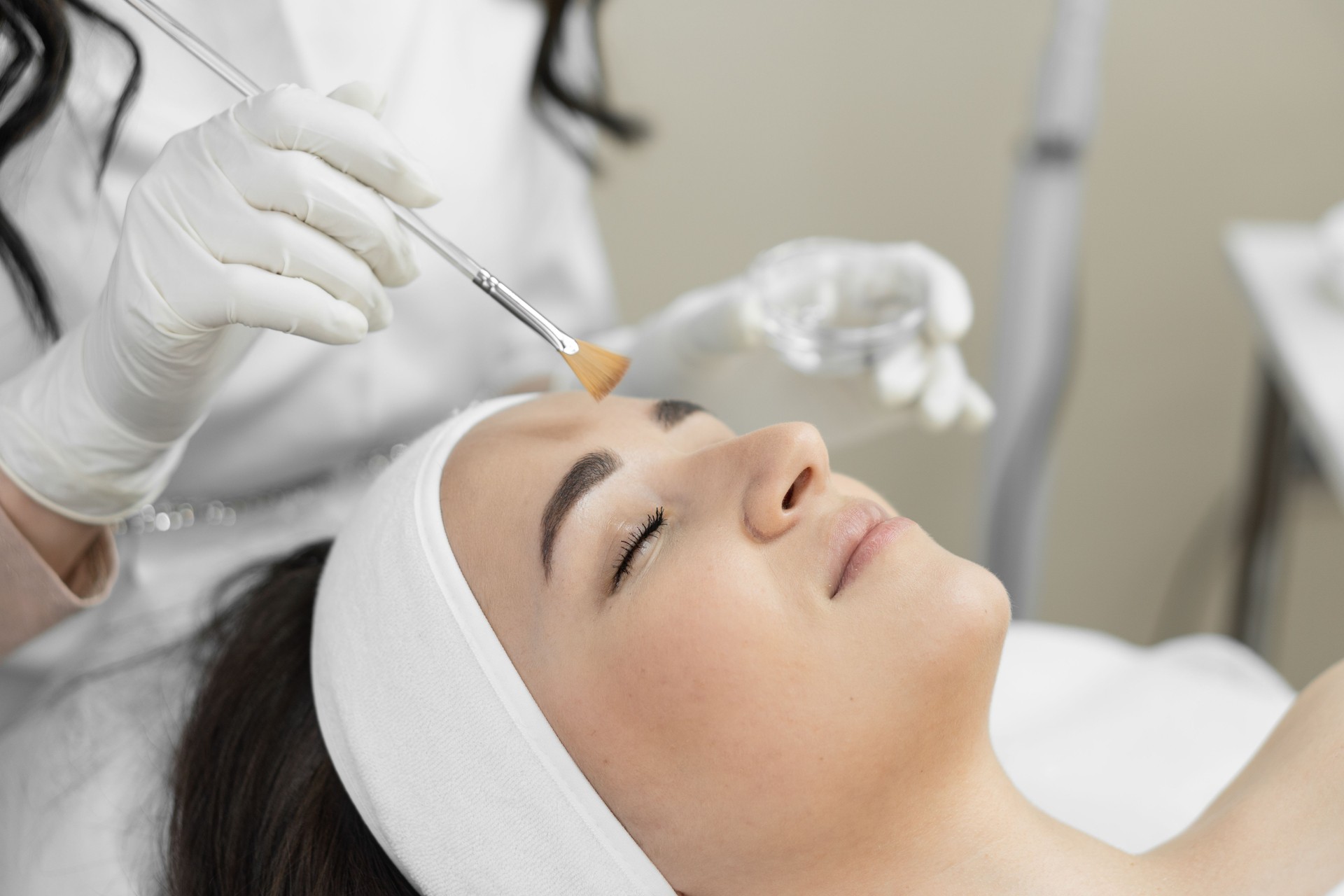 You can carefully consider procedure facial peeling, which helps to remove dead cells and improve structure skin in beauty clinic with professional cosmetologist. Young beautiful woman resting